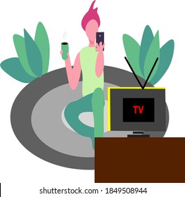 a young man sits relax playing his smartphone while drinking coffee and watching television