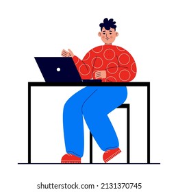 Young man sits at a table with a laptop. Distance learning concept, e-learning, remote work from home, freelance, courses. Student learns using a computer.