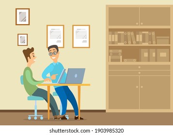 Young man is sitting at a desk with laptop, his colleague is pointing to a screen and giving advice. Office workers discussing work moments. Business meeting and communication. Friendly team work