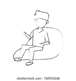Young man sitting on bean bag