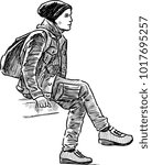 A young man sitting on a bench