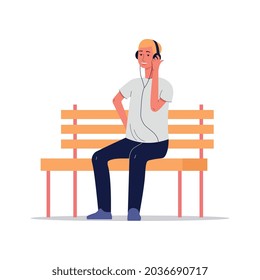 A young man is sitting on a bench and listening to music or radio online. A guy with headphones is enjoying music. Vector cartoon flat illustration isolated on a white background.