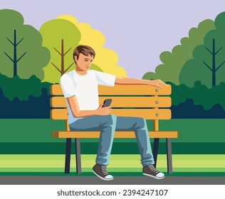 Young man sitting on the park bench with a cellphone