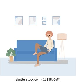 A young man is sitting on the sofa with a laptop in his hands. The boy studies and rests at home, online training and recreation.