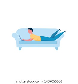 Young man sitting on soft sofa and working on laptop