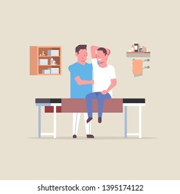 young man sitting on table professional masseur therapist doing healing treatment massaging patient body manual therapy physiotherapy concept full length