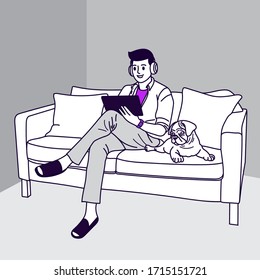 Young man is sitting with tablet on the sofa at home. Working on a tablet. Freelance, online education or social media concept. man with cute dog at the quarantine time because covid-19