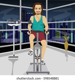 young man with smartphone armband on an exercise bike in gym in evening