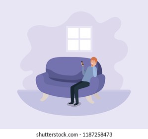young man with smartphone at the sofa