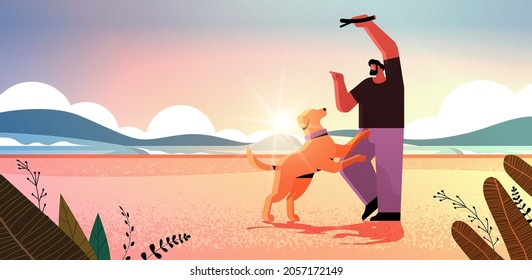 young man spending time with dog male owner and cute domestic animal having fun friendship with pet concept