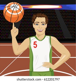 Young man spinning basketball ball with his finger on court in arena