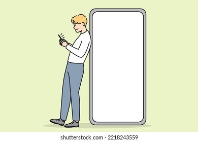 Young man standing near huge smartphone with mockup screen. Guy pose near cellphone with empty blank copy space display. Vector illustration. 