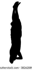 Young man standing on his head in a pose Sirshasana