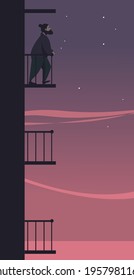 A young man stands on the balcony against the background of the evening sky. Loneliness illustration.