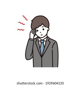 A young man in a suit suffering from a headache