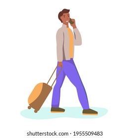 Un joven con una maleta está caminando y hablando por teléfono.
