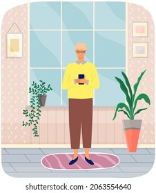 Young man surfing internet and communicating by phone typing message. Person spends time with smartphone standing at home in living room. Concept of using Internet application and modern gadgets