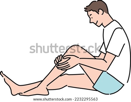 Young man touching his shin