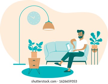 Young man using laptop at home working as freelancer 