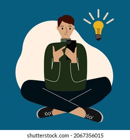 Young man using phone, sitting cross-legged and coming up with ideas. The concept of finding an idea and inspiration