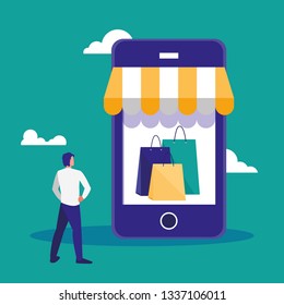 young man using smartphone with shopping bag