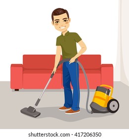 Young man using vacuum cleaner on his living room