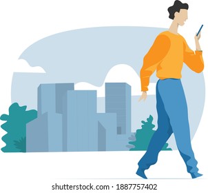 Young man walking in the city using his cellphone