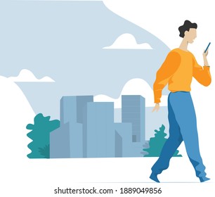 Young man walking in the city using his cellphone