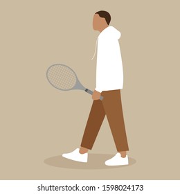 Young man walking with a tennis racket in his hand