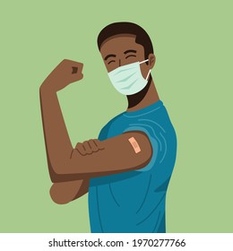 A young man wearing protective mask showing her arm with bandage after receiving covid-19 vaccine.