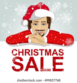 young man wearnig santa hat leaned on blank board with red christmas sale text