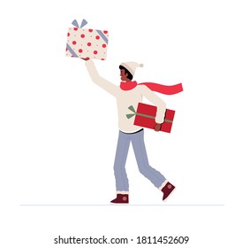 Young man in winter clothes smiles and holds gifts. Christmas celebration concept