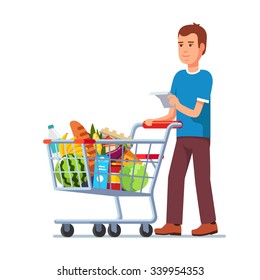 Young Man Wish Shop List Pushing Supermarket Shopping Cart Full Of Groceries. Flat Style Vector Illustration Isolated On White Background.