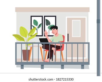 Young man working using laptop on balcony