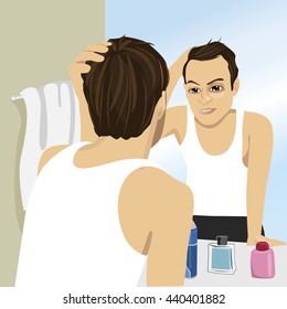 Young man worried about hair loss while looking in a mirror