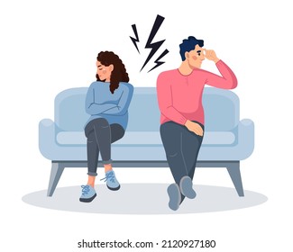 A young married couple has problems in their relationship. A woman and a man are sitting on the couch and don't want to talk to each other. The concept of a family quarrel, divorce. Domestic conflict
