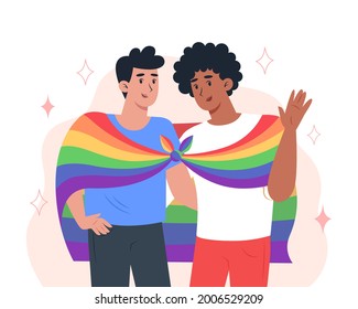 Young men couple hug each other and hold a rainbow LGBT pride flag