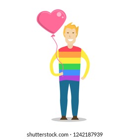 Young men wearing a rainbow t shirt and holding a heart shape balloon. LGBT