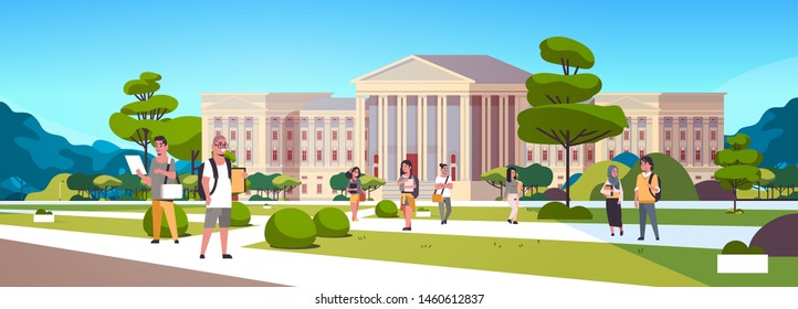 young mix race students group at campus yard education concept college friends relaxing and walking in front of university building exterior horizontal full length - Shutterstock ID 1460612837