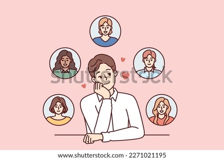 Young monogamous man thinks about girls while choosing which fan to invite on romantic date. Monogamous guy loves several women at same time and introduces them while sitting at table
