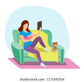 A young mother on the couch breastfeed a newborn baby
