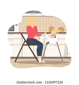 Young mother is sitting on the chair with little spoon and jar of baby puree in her hands, feeding her baby, who is sitting in a child's chair. Cozy kitchen interior background with furniture, stove.