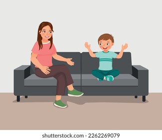 Young mother talking to her son sitting on sofa giving advises encouragement and support 