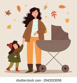 Young mother walks with a stroller and a child in the park. Autumn walk. Happy childhood. Motherhood.