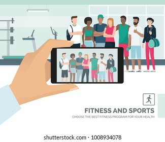 Young multi-ethnic sportspeople posing together at the gym, a man is taking a picture and sharing it online, subjective point of view