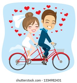 Young newlywed couple riding on tandem bicycle just married concept