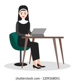 Young nun with personal computer in home office