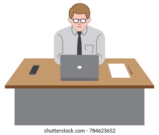 A young office worker is using his laptop on his desk