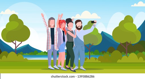 young people group taking selfie photo on smartphone camera casual friends men women having fun posing outdoor nature landscape mountains background full length horizontal