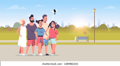young people group using selfie stick taking photo on smartphone camera friends standing together city urban park sunrise landscape background full length horizontal vector illustration
